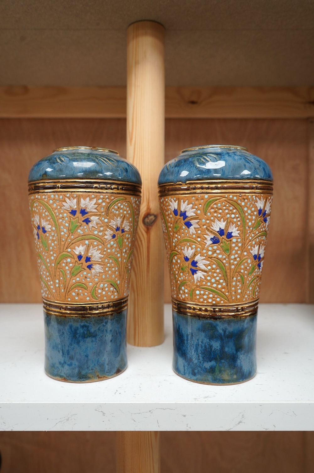 A pair of Royal Doulton Lambeth stoneware vases, 20cm high. Condition - good